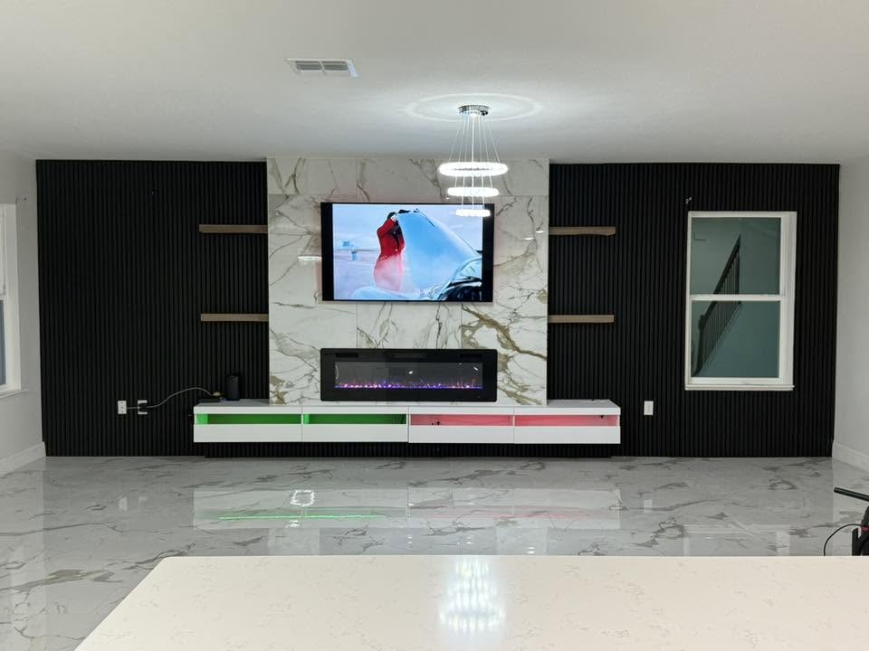 Finished accent wall with TV mount and fireplace